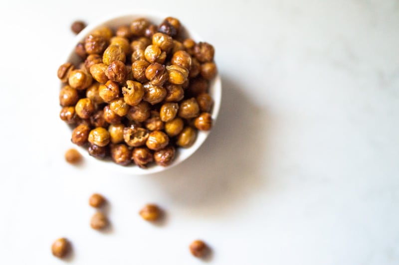 Small bowl of crispy roasted chickpeas on bench