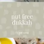 Small wooden bowl filled with nut free dukkah. In the background is some sliced sourdough bread and a bowl of olive oil. Text overlay reads nut free dukkah feel good eating