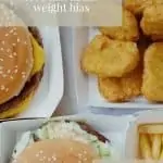 Flat lay of fast food. There are burgers, nuggets, fries, wedges and sauces. Text overlay reads: Let's talk about weight bias. Feel good eating.
