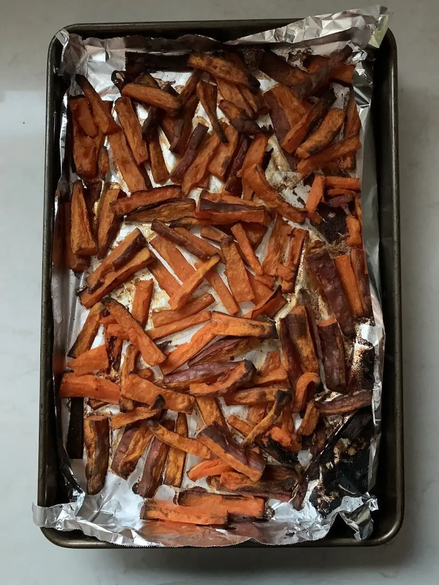 A tray of burnt sweet potato wedges
