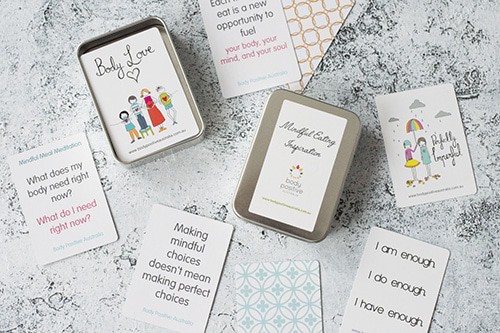 A flatlay of scattered affirmation cards