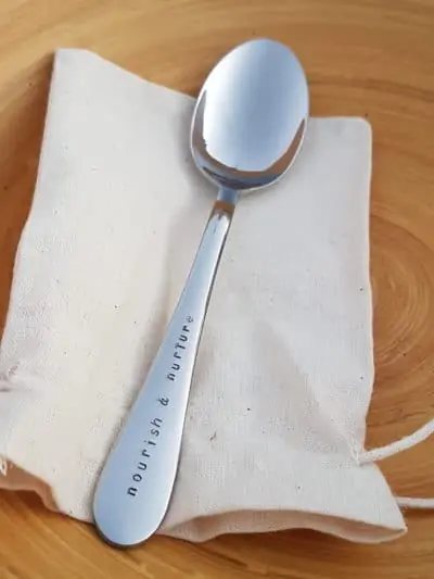 A silver spoon on a cloth bag.