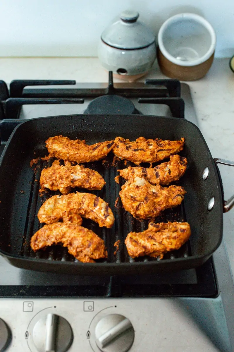 A griddle pan of Tandoori Chicken tenderloins