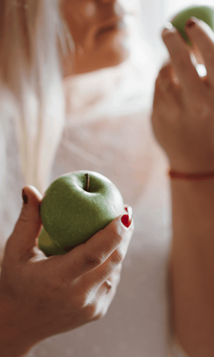 Woman contemplating eating an apple