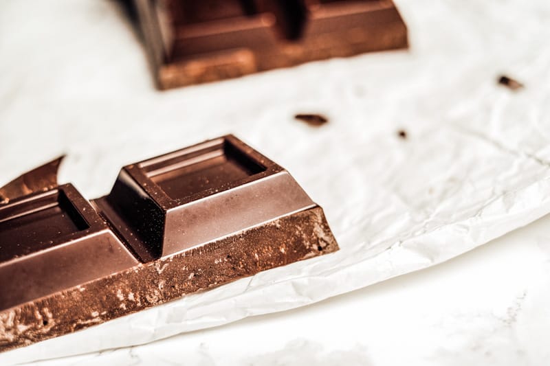 A close up of two squares of chocolate.