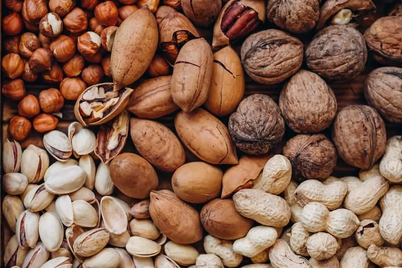 A close up of walnuts, peanuts, pistachios, hazelnuts