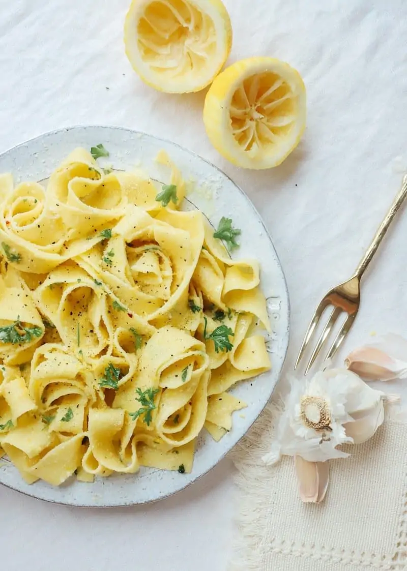 Bit plate of pappardelle pasta with some herbs, garlic and lemon.